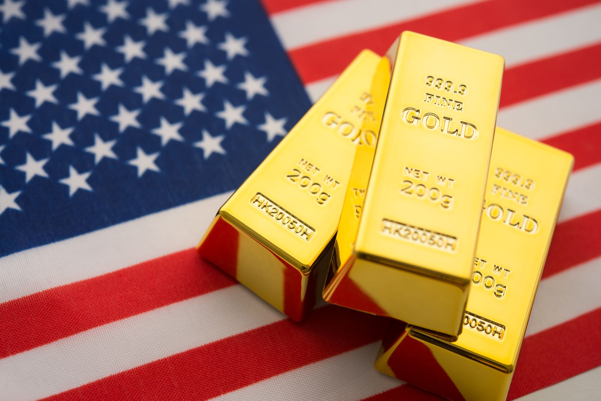 Gold bars with American flag background.